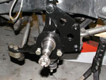 Spindle with caliper bracket mounted on the car.