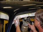 Dan sprays glue on the edges of the headliner