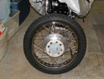 Right side of rear wheel with new tire and sprocket installed
