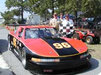 The crew proudly displays the checkered flag