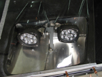 A close-up of the mounted headlights with the plastic covers