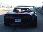 Vette on pit road with the Chevrolet walk-over bridge